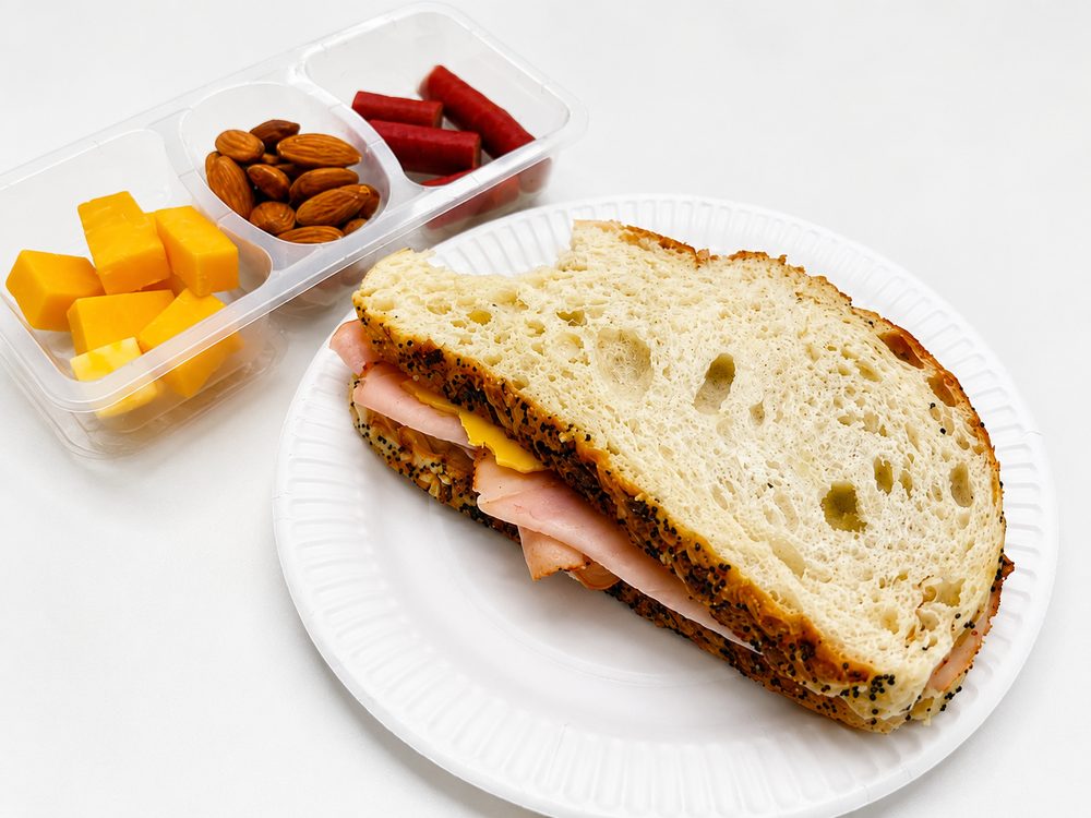 Meal photo sent to NanoRhino: turkey ham sandwich with cheese cubes, almonds and beef sticks